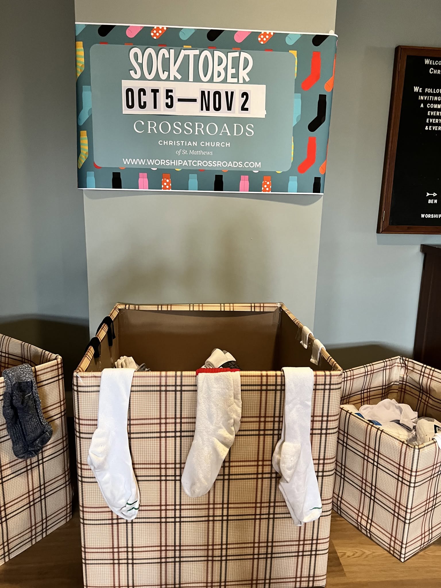 Socktober sign above bins of donated socks at Crossroads